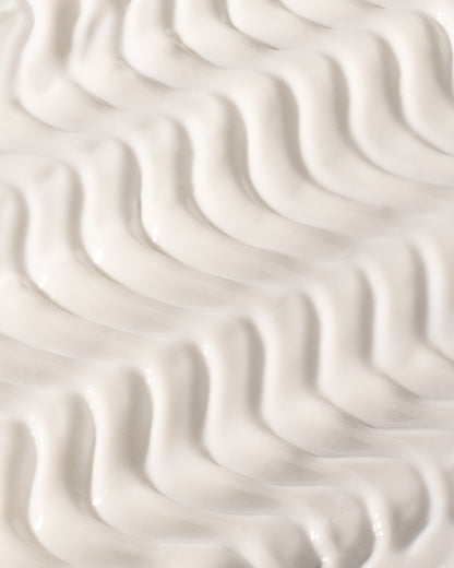 The Sun, DF18+ face sunscreen serum with SPF 50+, shown with its texture.