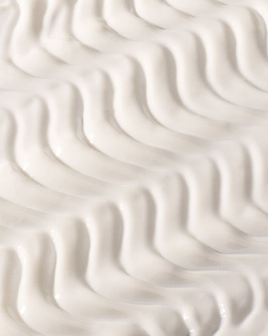 The Sun, DF18+ face sunscreen serum with SPF 50+, shown with its texture.